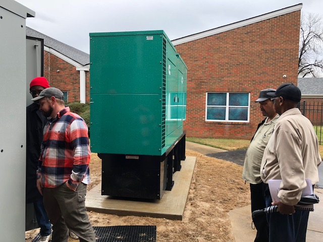 Fayette County elderly lady gets help from son in choosing a Cummins home standby generator from Benchmark Electric