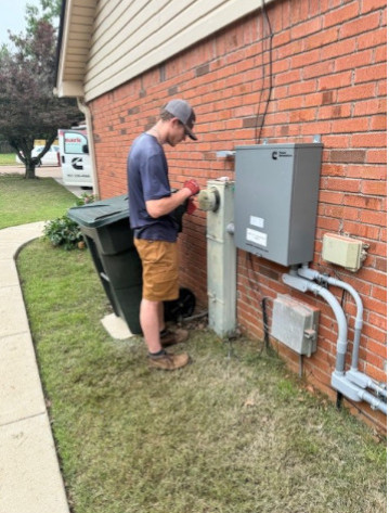 Benchmark Electric technician completing installation of a Cummins Home Standby Generator